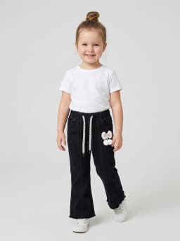 Girls Black Denim Flared Pants with Raw Hem and Charm Accent